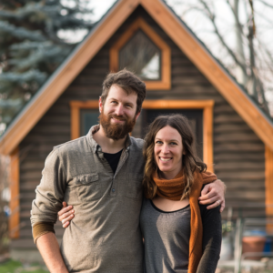A family of three enjoys a sunny day outside their stylish yet budget friendly A frame home